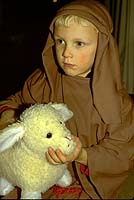 Boy draped in burlap in christmas nativity play